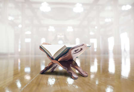 Quran or Kuran, the islamic holy book, in blur background, with light source