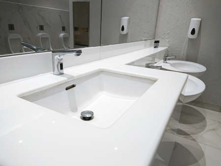 close up on a faucet of a sink in modern bathroom for interior designの写真素材
