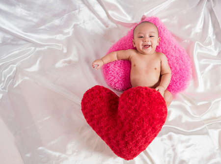 cute asian four-month baby smiling with heart and love in valentine festival, Happy valentine concept.の写真素材