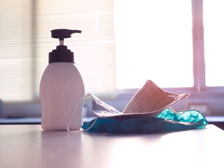 closeup of protective set of alcohol gel, mask , and rubber glove  to disinfection of covid -19 and other bacteriaの写真素材