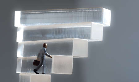 conceptual businessman figures with clear blocks, standing in the leader position among other...