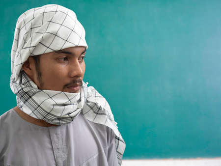 portrait of young Muslim man in traditional dress ready to pray, showing his faith in  Allah (Muslim God)の写真素材