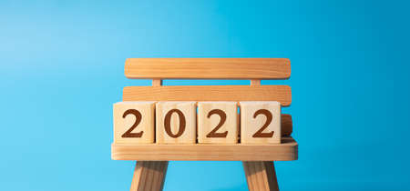 year of 2022 printed on wooden blocks on cyan backgroundの写真素材