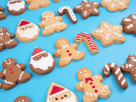 Christmas homemade gingerbread cookies on the cyan background for decoration and celebration