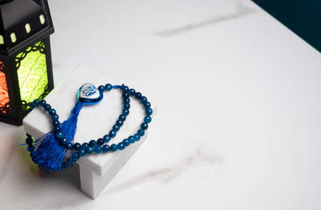 Rosary beads and heart shape with the arabic text "Allah" placed on marble stone , for muslim pray and fasting ramadan monthの写真素材