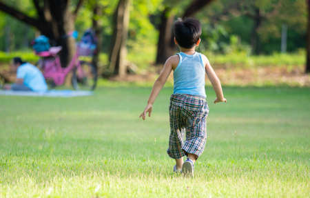An asian boy playing outdoor activity with excited on something new, learning via outdoor activity, child will going to large world to grow up in the future.の写真素材