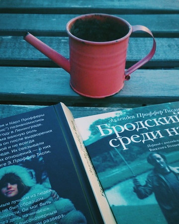 Book and watering can on wooden tableの素材