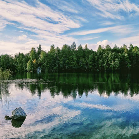 Blue lake and pine treesの写真素材