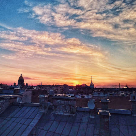 Beautiful sunset over Saint Petersburg, view from a roof to the city centerの写真素材