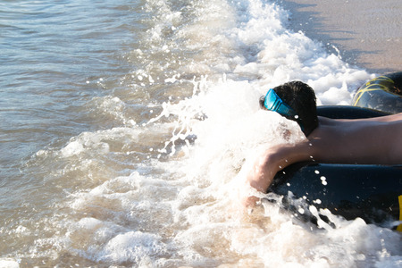 boy playing sea waterの写真素材