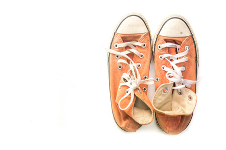 old sneakers isolated on whiteの写真素材