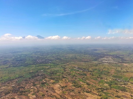 Aerial view of agricultural field against beautiful blue sky