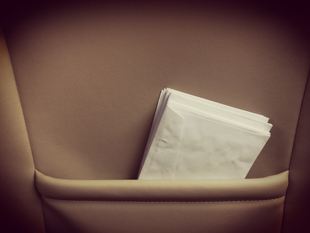 White envelope in classic leather bag.