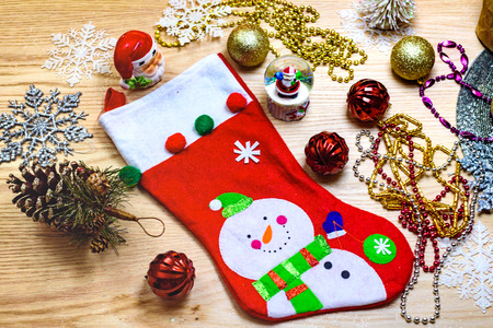 Christmas sock and ornaments on the wooden table