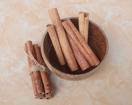 cinnamon stick in wood bowlの写真素材