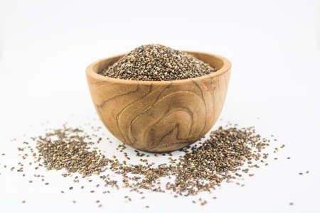 Closeup Chia Seed in wood bowl with white backgroundの写真素材