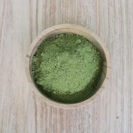 top view Moringa leaf powder in a wooden bowlの写真素材