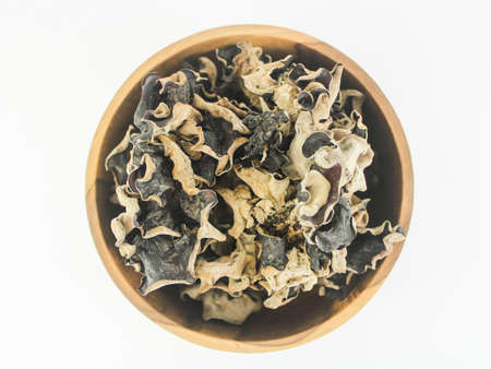 Ear Mushroom in wood bowl with white backgroundの写真素材