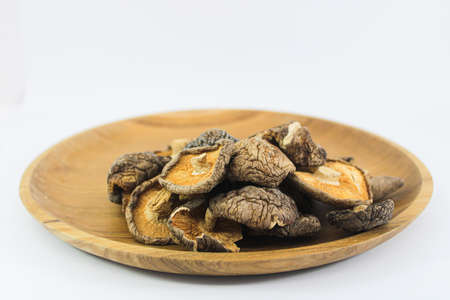 Close up Shitake Mushroom and Cinnamon in wood plateの写真素材