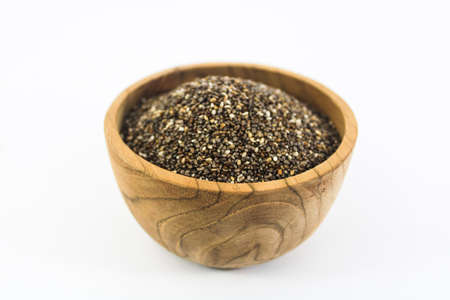 Closeup Chia Seed in wood bowl with white backgroundの写真素材