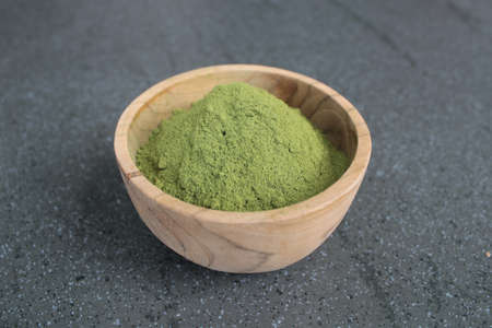Moringa powder in a wood bowl closeupの写真素材