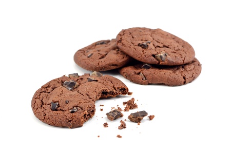 Chocolate chip cookies with bite missing on a white background