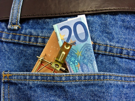 Money on a mouse trap in back pocket of denim jeansの写真素材