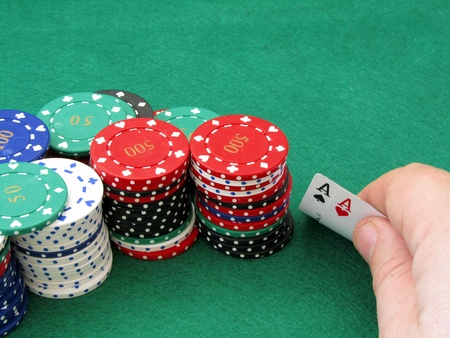 A poker player seeing that he has been dealt a pair of aces