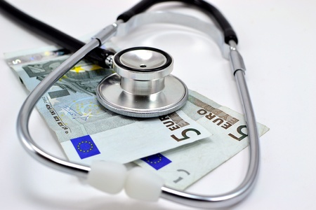 Stethoscope lying on 10 euros doctors feesの写真素材