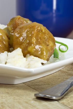 Meat balls in gravy on a white plateの写真素材