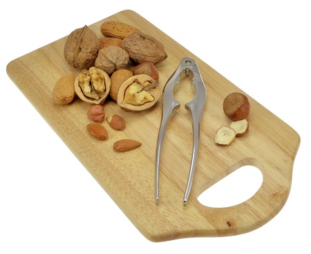 Selection of nuts on an isolated wooden board 