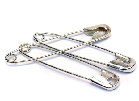 Safety pins on a white background