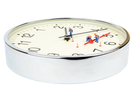 Miniature workmen fixing a broken clock on white background