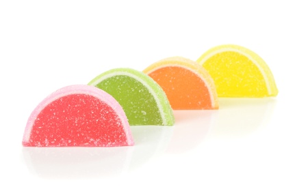 A row of sugar coated fruit jelly sweets on a white backgroundの写真素材