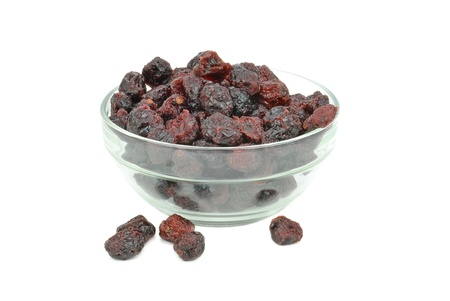Dried cranberries in a glass bowl on white backgroundの写真素材