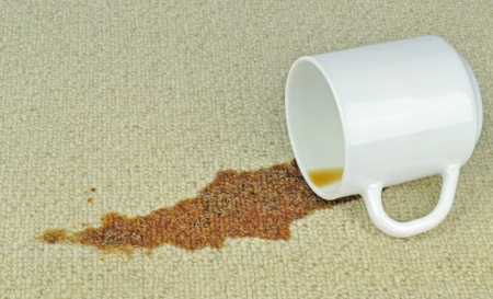 A spilled cup of coffee on a carpet with stainの写真素材