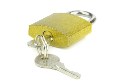 A golden coloured padlock with keys on a white background