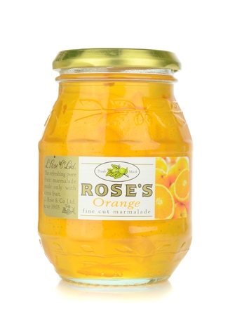 NIEDERSACHSEN,GERMANY 03 08 2014  A glass jar of Roses orange marmalde on a white backgroundのeditorial素材