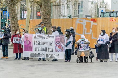 BERLIN, GERMANY APRIL 13, 2019: A group of peaceful silent protestors demonstrating in Berlin with a banner showing a picture of Abdullah Oecalanのeditorial素材