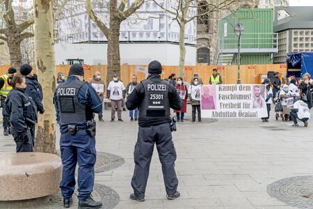 BERLIN, GERMANY APRIL 13, 2019: A group of German police officer standing in front of a group of protestors in Berlin during a silent demonstration for Abdullah Oecalanのeditorial素材