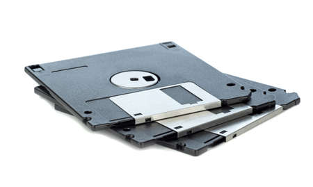 A small pile of 3.5 inch computer floppy discs lying on a white background