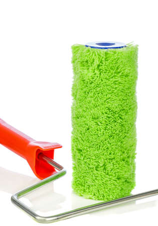 A green fluffy paint roller and handle on a white background with copy space for your textの写真素材