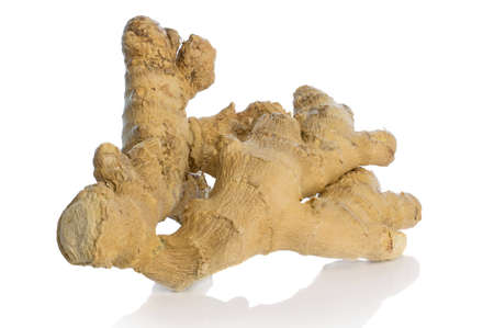 A piece of not so fresh ginger with wrinkled surface on a white backgroundの写真素材