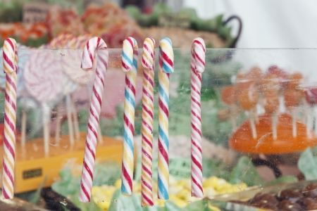 candy canes hanging from the glassの写真素材