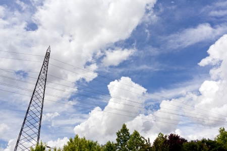 high voltage pylon against cloudy skyの写真素材