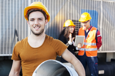 young workers in a junkyardの写真素材