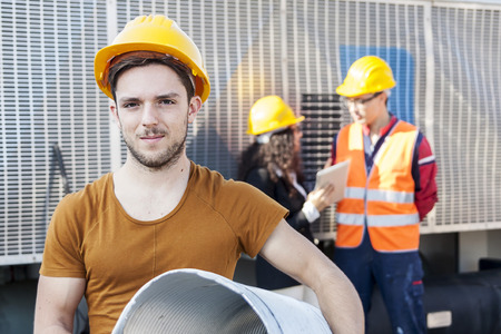 young workers in a junkyardの写真素材