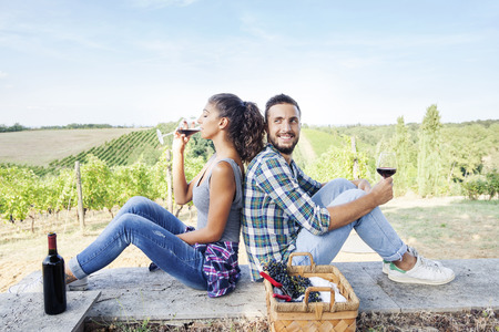 young couple toasting in a vineyardの写真素材