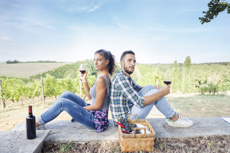 young couple toasting in a vineyardの写真素材
