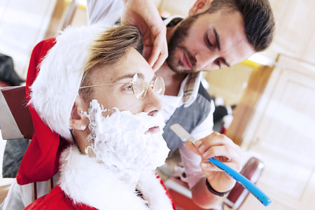 santa claus cut beard from his personal barberの写真素材